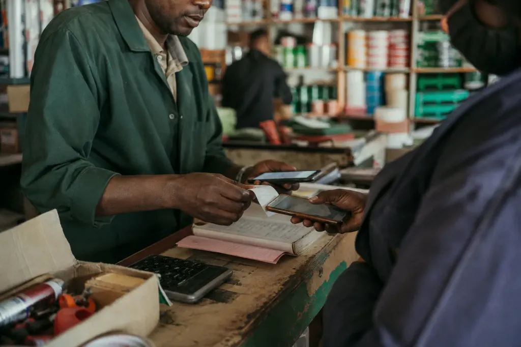 Business counter where phone, paper record and calculator are all part of the same transaction